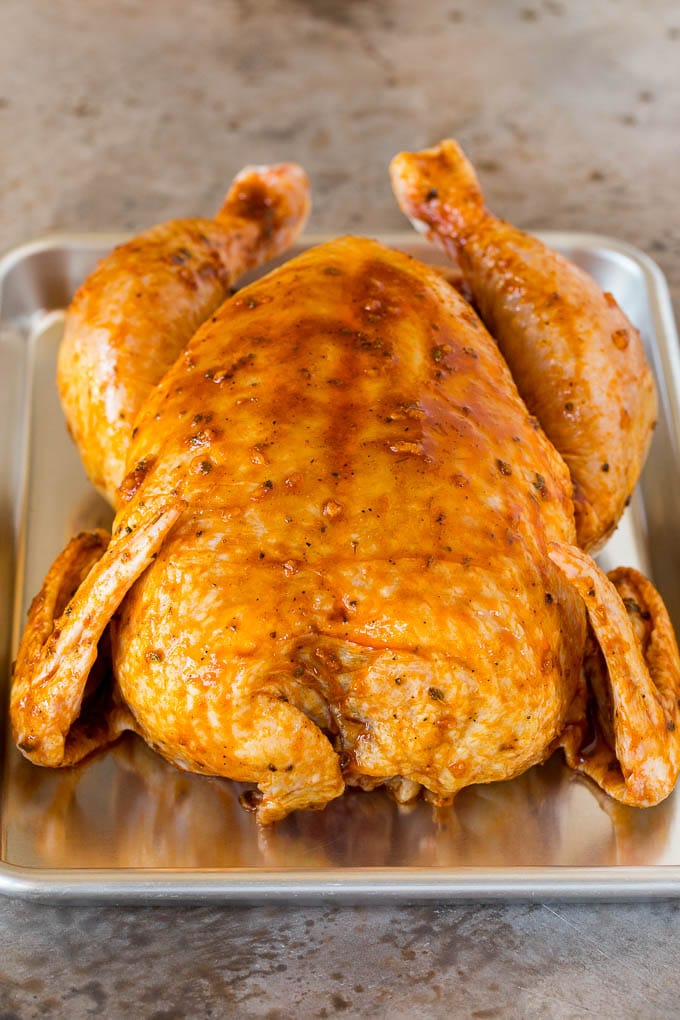 A chicken coated in marinade.