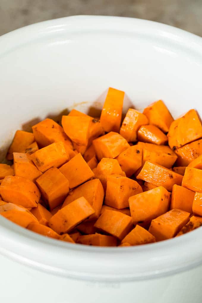 This crock pot sweet potato casserole is yams mashed with sweetener, vanilla and spices, then finished off with a brown sugar pecan topping. Diced yams in a slow cooker.