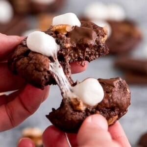 An image of a rocky road cookie being pulled apart.