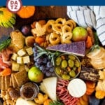This Thanksgiving charcuterie board is a display of meats, cheeses, nuts, crackers, fall fruit and seasonal treats.