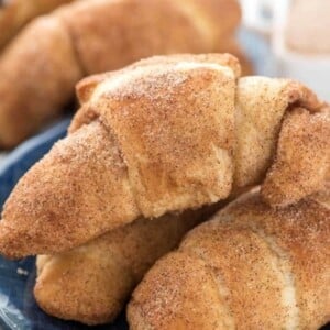 An image of several churro crescent rolls on a plate.