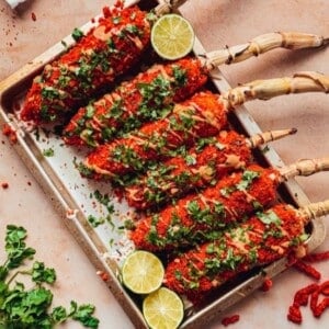 A tray with several elotes made with Flaming Hot Cheetos.