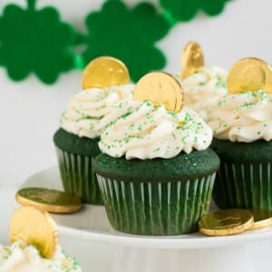 An image of several green velvet cupcakes on a platter.