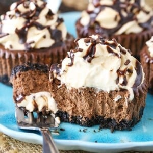 An image of a mini Baileys chocolate cheesecake cut in half with a fork.