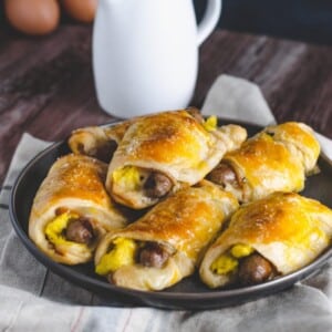 An image of sausage egg and cheese crescent rolls on a plate.