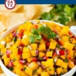 This sweet and savory mango salsa is a blend of juicy mango, peppers, onions and cilantro, all tossed together and seasoned with lime juice.