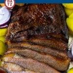 A pan of smoked brisket which is beef coated in a homemade spice rub, then slow smoked to tender perfection.