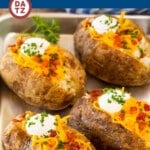 These oven baked potatoes are perfectly cooked with a crispy outside and fluffy inside.