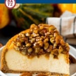 A slice of pecan pie cheesecake on a small plate.