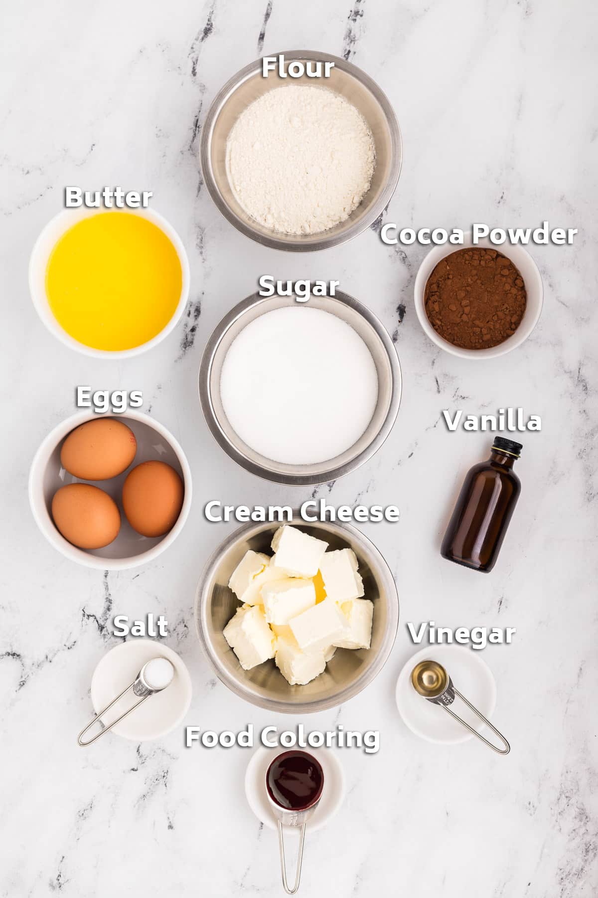 Bowls of ingredients including eggs, butter, sugar, flour and cocoa powder.