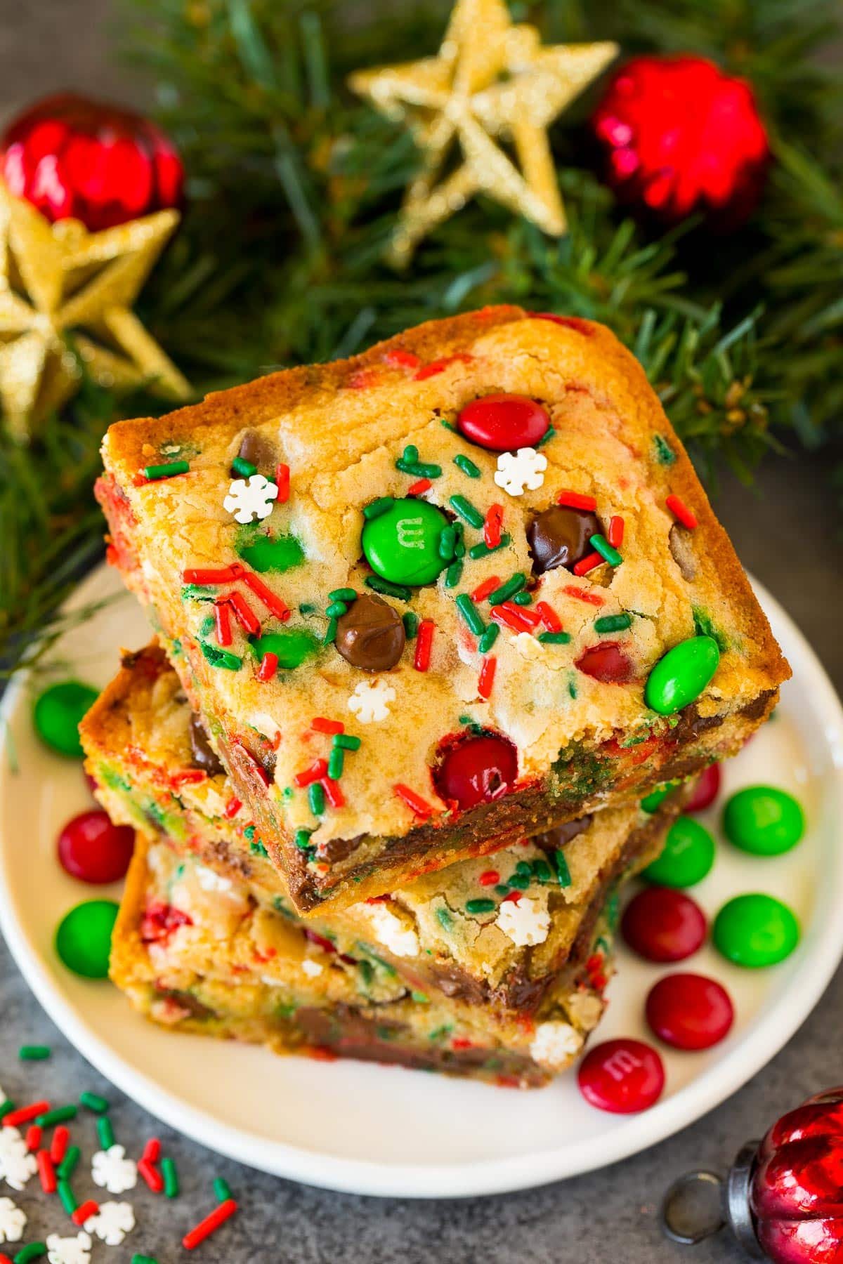 A stack of Christmas cookie bars on a plate.