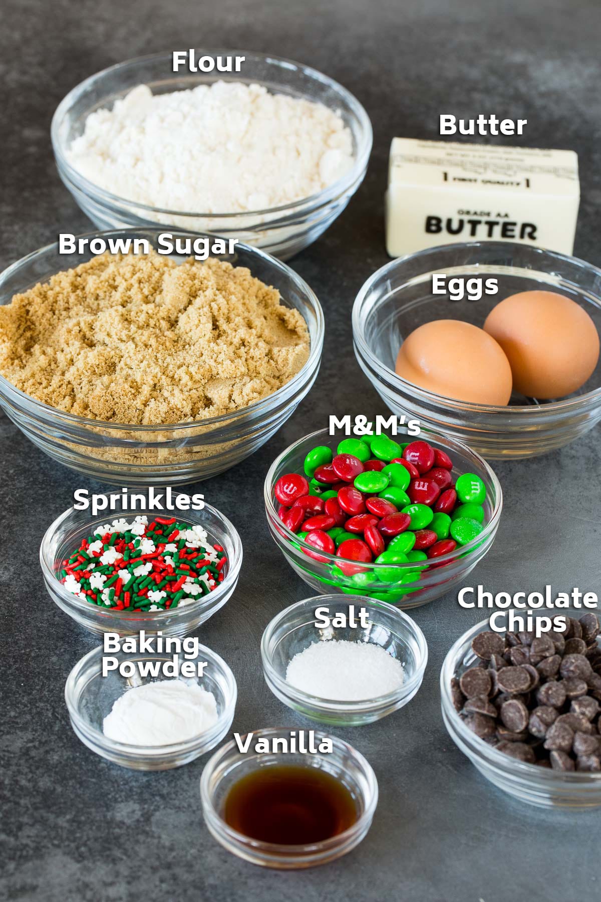 Bowls of ingredients including flour, brown sugar, eggs, vanilla and chocolate.