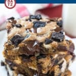 A plate with three Oreo bars with dark and white chocolate chips and crushed Oreo cookies.
