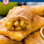 Several fried apple pies stacked on a plate.