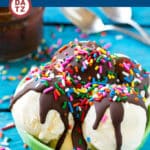 A bowl of vanilla ice cream topped with homemade magic shell and sprinkles.