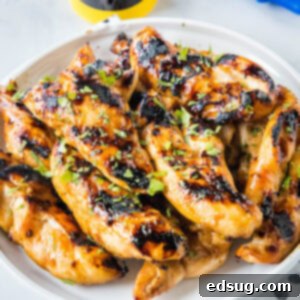Teriyaki grilled chicken piled on a white platter.