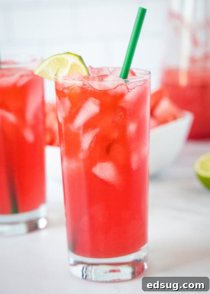a glass filled with watermelon soda and a straw