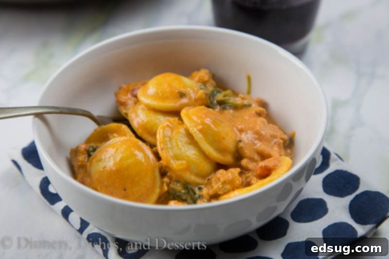 Creamy sausage and tomato ravioli in a large skillet, ready to be served, showing the rich sauce and vibrant ingredients.