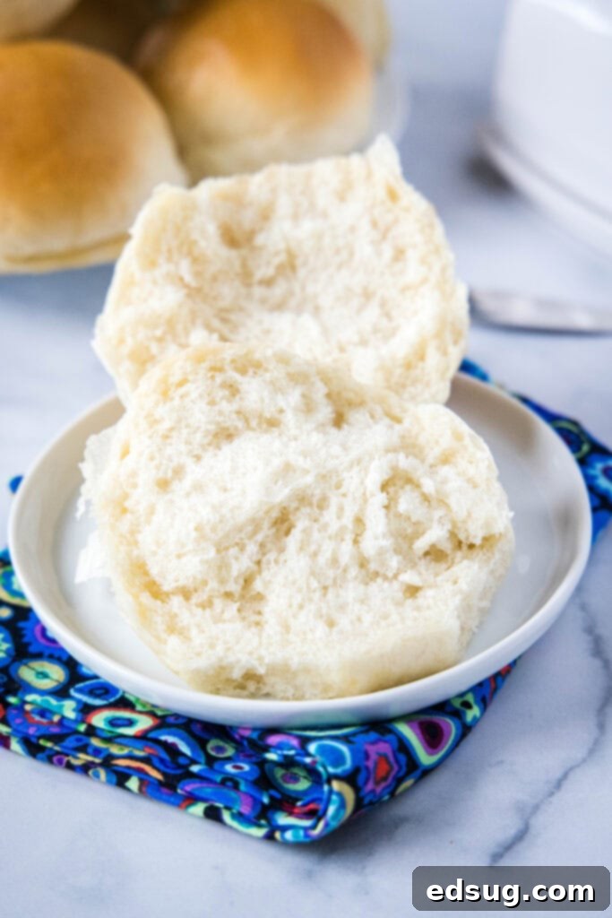 Crusty French Dinner Rolls 3 A French bread roll cut in half, revealing its soft, airy texture