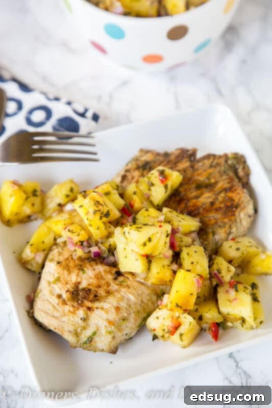 A plate of Jerk Chicken with Grilled Pineapple Salsa, a perfect combination of spicy and sweet.