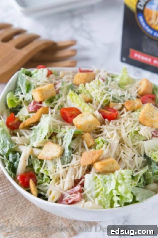 Another view of the Caesar pasta salad in a white serving bowl, ready for a gathering or a delicious family meal.