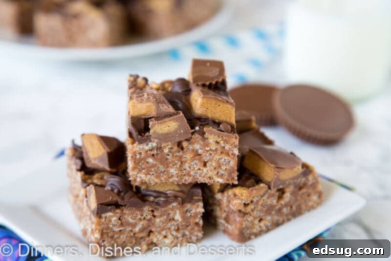 Close-up of Reese's Peanut Butter Rice Krispie Treats showing the chocolate drizzle and peanut butter cups.