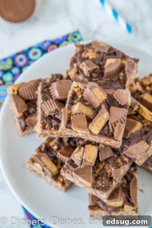 Several Reese's Peanut Butter Rice Krispie Treats displayed on a plate, highlighting their decadent appearance.