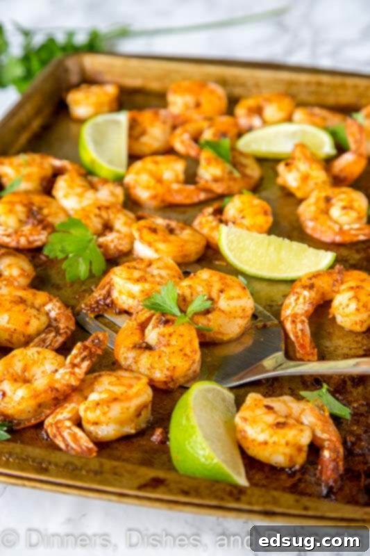 A tray of baked shrimp, perfectly cooked and lightly spiced