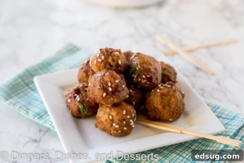 slow cooker honey garlic meatballs on a plate with fresh parsley
