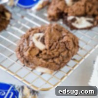 Close up of a Peppermint Patty Fudge Cookie on a cooling rack, fudgy and soft.