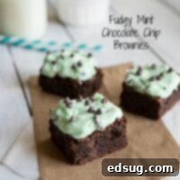 Fudgy Mint Chocolate Chip Brownies on a wooden board, rich and delicious.