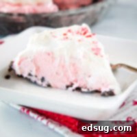 Cropped picture of Candy Cane Pie on a plate, a no-bake peppermint cheesecake.