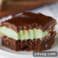 A square Grasshopper Brownie with green frosting on a white plate.