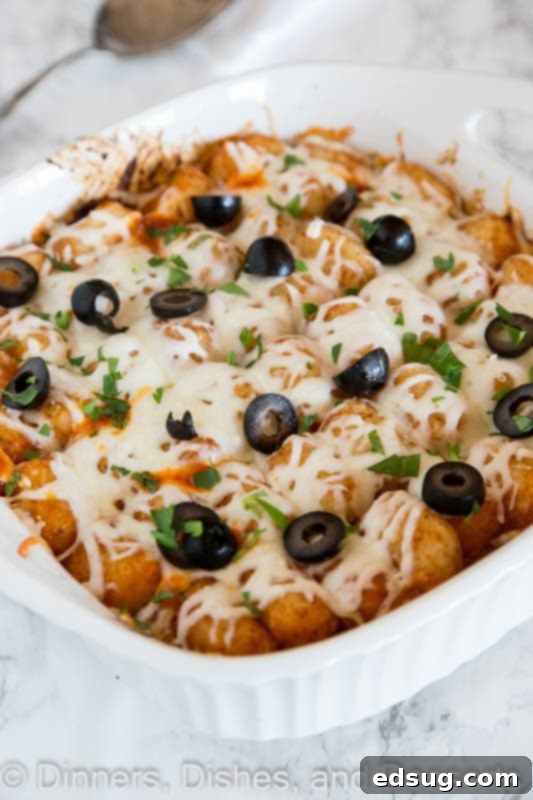 A dish of a delicious pizza tater tot casserole, freshly baked and bubbly.