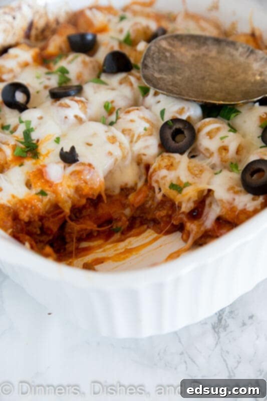 A freshly baked pizza tater tot casserole in a baking dish, ready to be served.