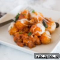 A close up of a delicious pizza tater tot casserole, ready to serve.