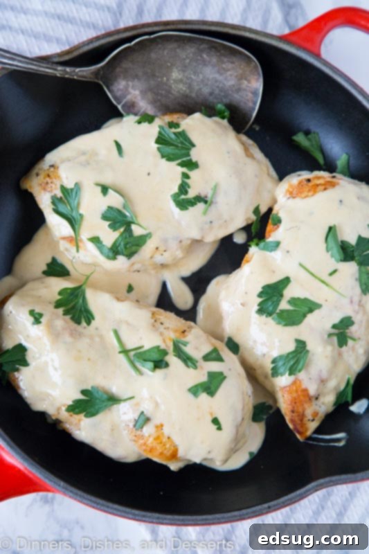 Juicy chicken breasts cooked until golden brown and topped with a tangy French pan sauce, served with fresh herbs.