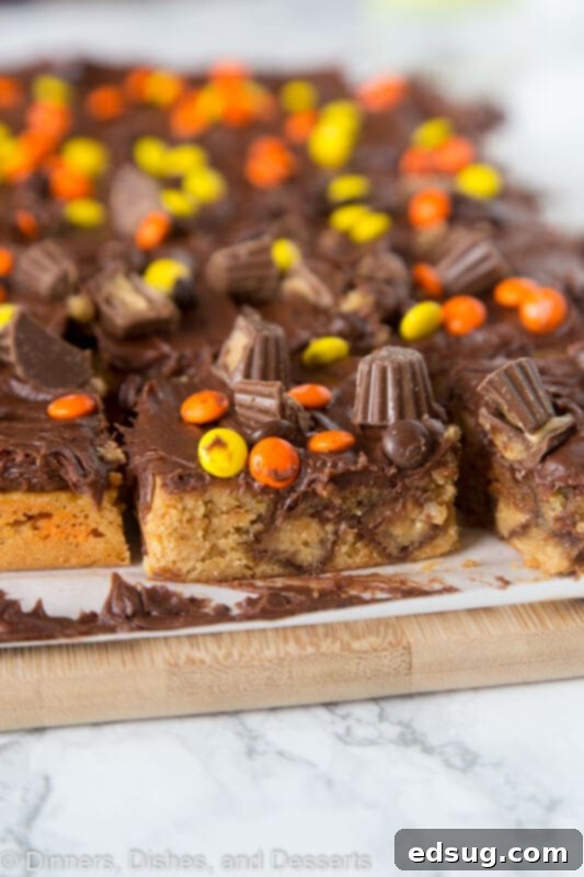 Delicious Reese's Peanut Butter Bars on a rustic wood cutting board