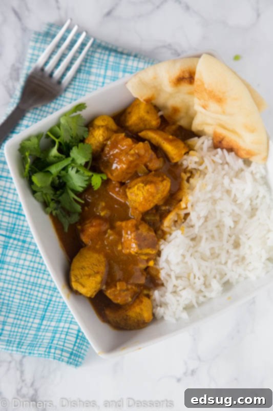 A close-up shot of creamy coconut chicken curry with rice, perfectly cooked and ready to eat.
