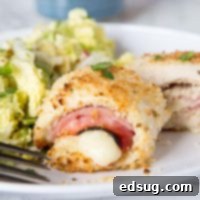 A close-up of a plate of Crispy Chicken Cordon Bleu, showcasing the melted cheese and crunchy crust.