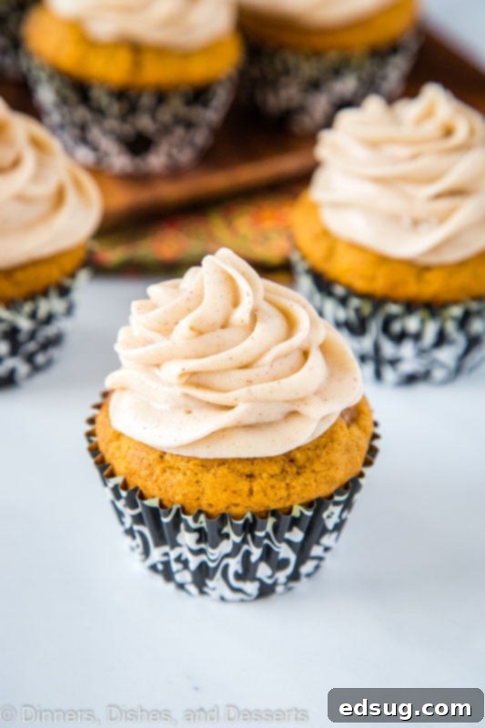 Pumpkin Spice Cupcakes, an autumnal delight, adorned with a swirl of cinnamon-flavored cream cheese frosting