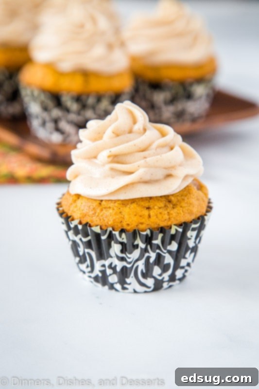 Pumpkin Cupcakes crowned with an elegant swirl of cinnamon cream cheese frosting, ready to delight