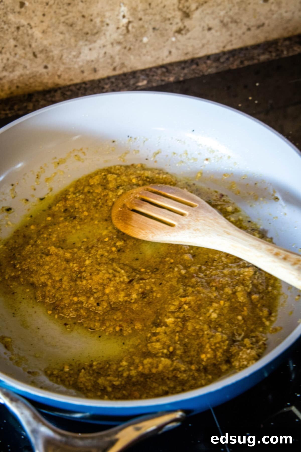Golden Garlicky Crumb Pasta 3 Close-up of golden breadcrumbs toasting in olive oil with minced garlic and red pepper flakes in a skillet.