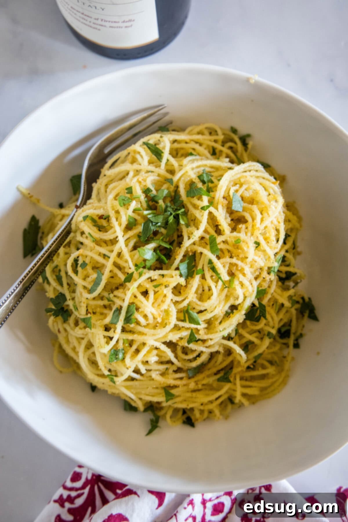 Golden Garlicky Crumb Pasta 5 Overhead shot of a bowl of spaghetti with crispy breadcrumbs, Parmesan, and fresh parsley, ready to be served.