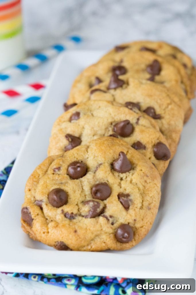 Thick and chewy chocolate chip cookies recipe spread out on a cooling rack