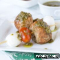 Italian Meatball Caprese Skewers - Make summer entertaining easy with these little skewers. An Italian style meatball, fresh Mozzarella cheese, and tomato, topped with a basil vinaigrette!