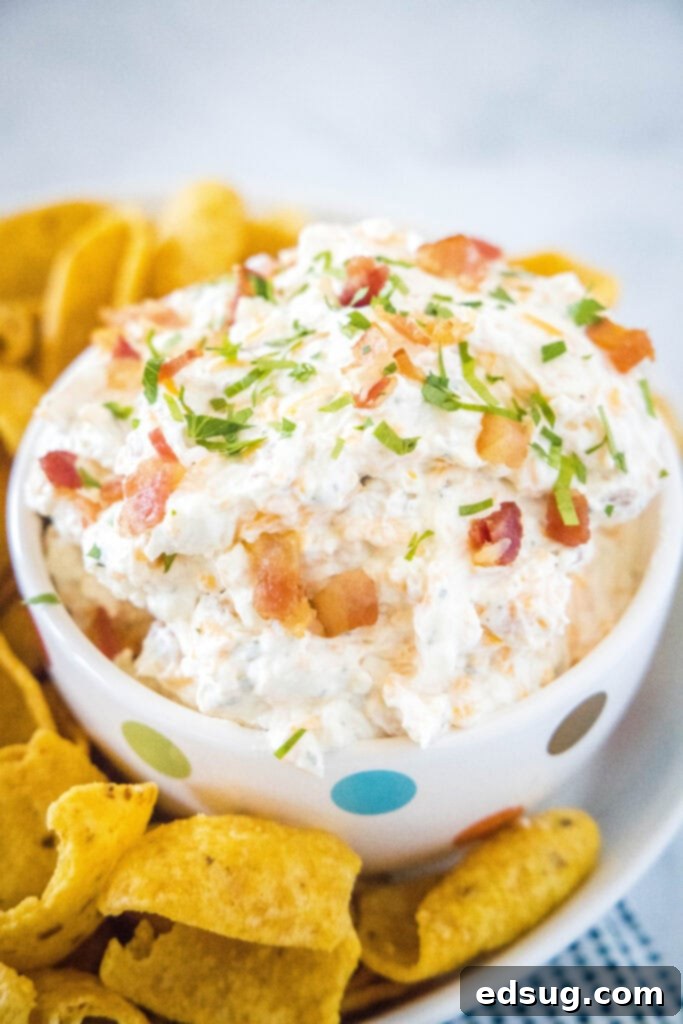 Creamy cheddar ranch dip in a rustic bowl, surrounded by Fritos Scoops and other dippers, ready to be enjoyed.