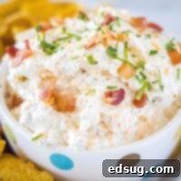 cropped square image of dip in a bowl with bacon on top