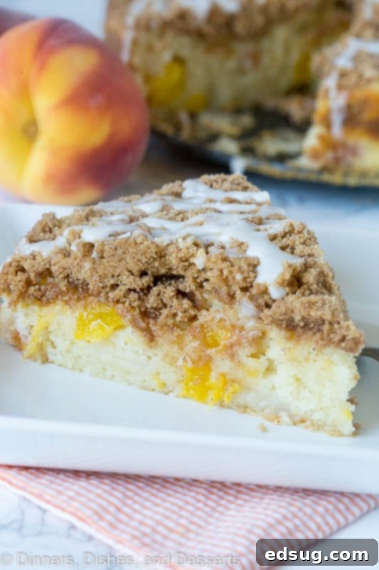 A piece of peach coffee cake on a plate