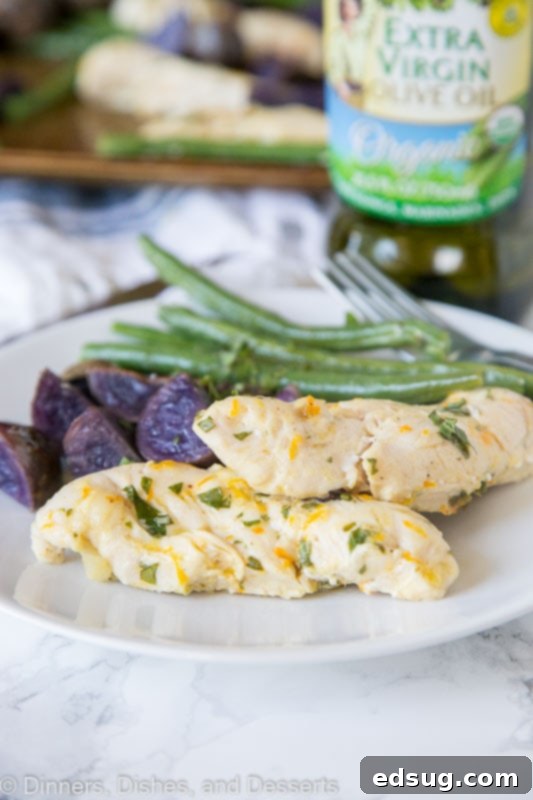 Baked chicken with purple potatoes and green beans served on a plate
